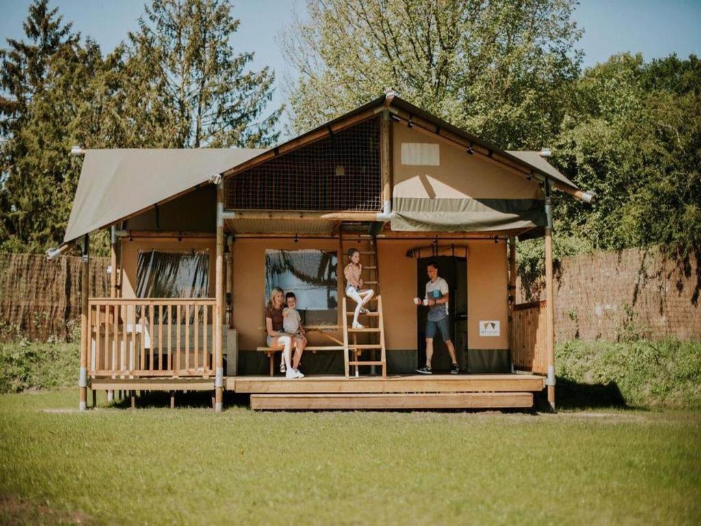 a house with people standing in the front of it at Luxury holiday home in Overijssel in Balkbrug