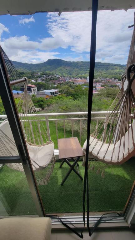a porch with two hammocks and a view of a yard at Espectacular apartamento en Guaduas in Guaduas