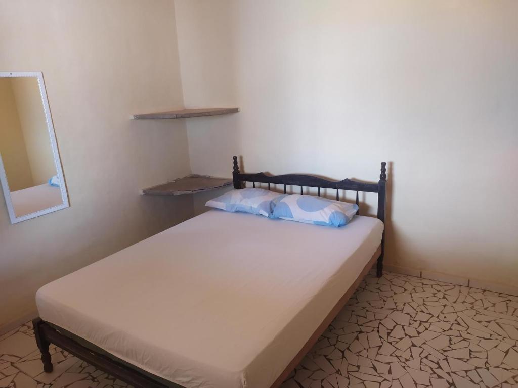 Ένα ή περισσότερα κρεβάτια σε δωμάτιο στο Aconchego Balbino hospedagem