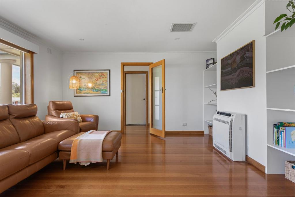 a living room with a couch and a table at Bonnie Belle, Norwood in Kings Meadows