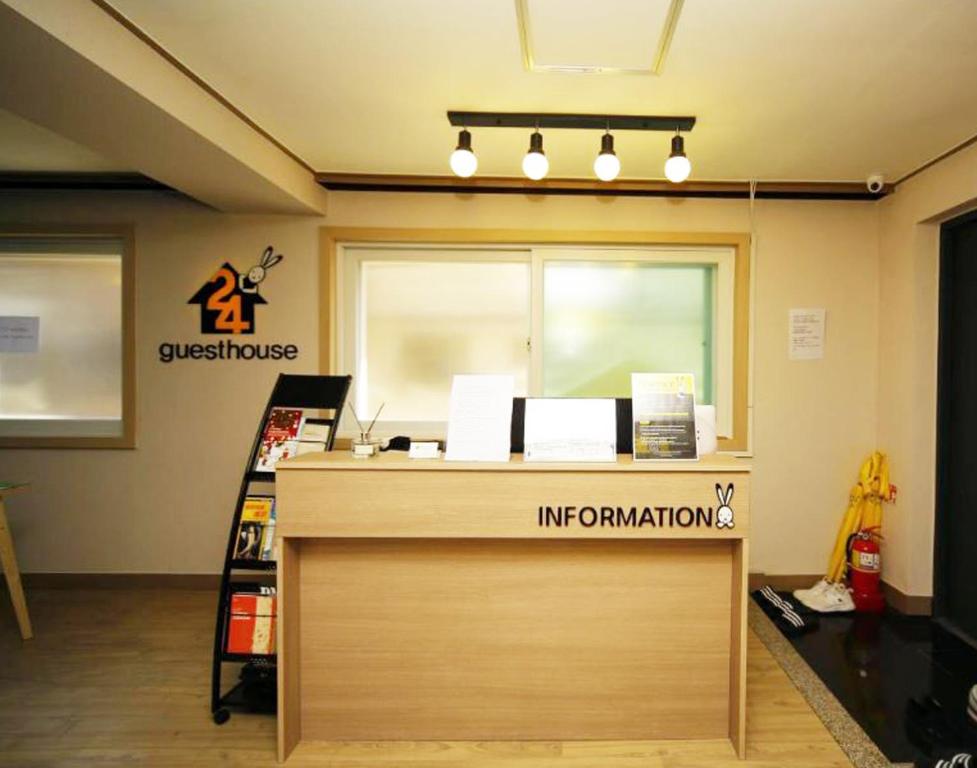 an office with a reception desk with a sign on it at 24 Guesthouse KyungHee University in Seoul