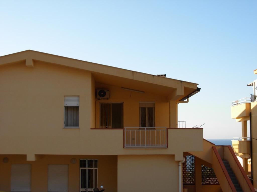 una casa con balcone e l'oceano sullo sfondo di Casa Vacanze Serena ad Alcamo Marina