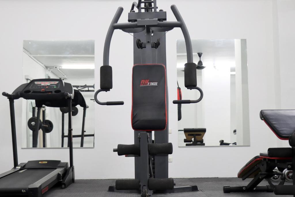 A compact fitness room with cardio and multi-function strength equipment.