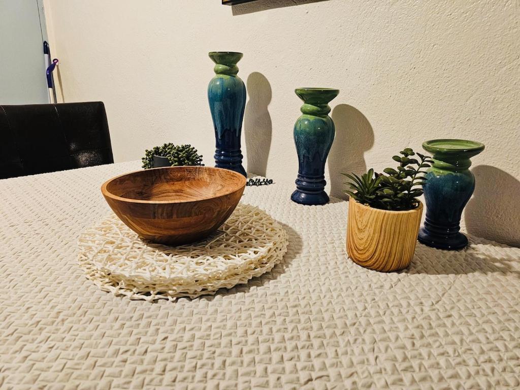 a group of vases sitting on top of a table at Pedro's Place Peaceful 1 bedrm, 1 bathrm Villa in Sinajana