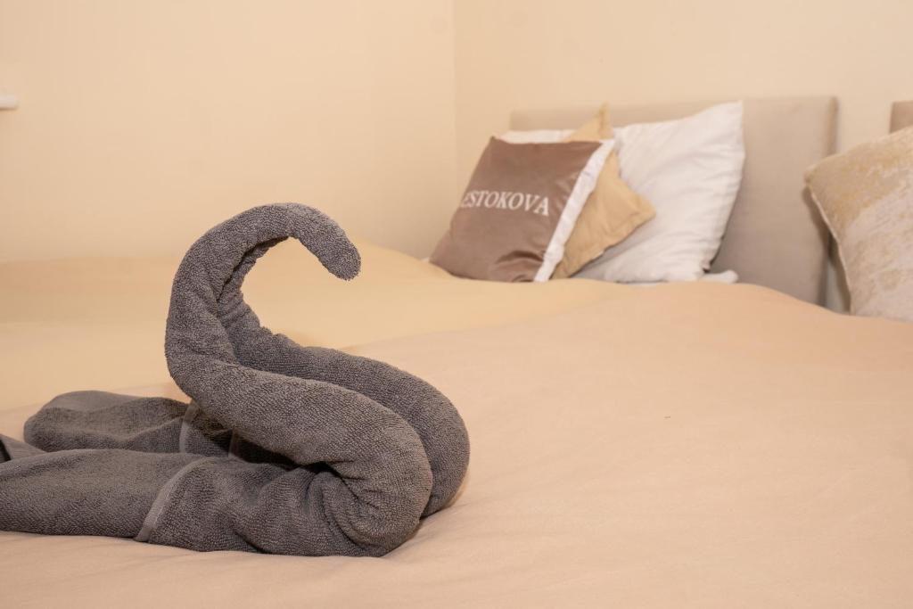 a swan sitting on top of a bed at Quiet Yellow Rest House Sleeps 7 in Swindon