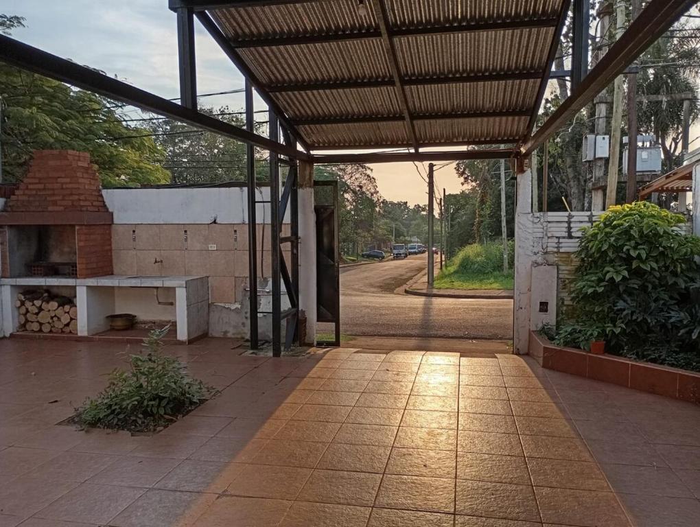 an outdoor patio with awning and a brick oven at Morada Donatella in Posadas