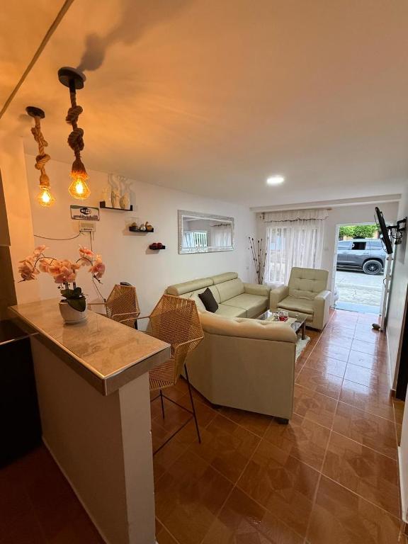 a living room with a couch and a table at Hostal Maxim in Lemos