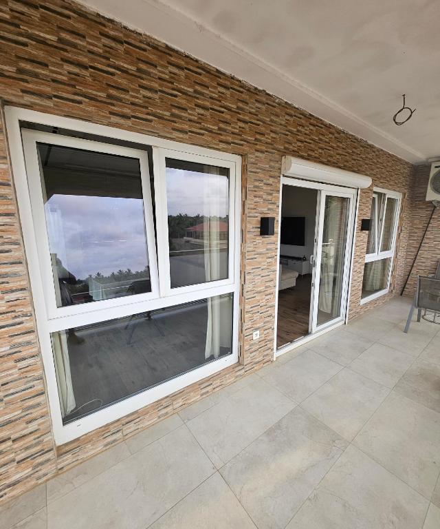 a patio with windows and a brick wall at Modern and bright light room 