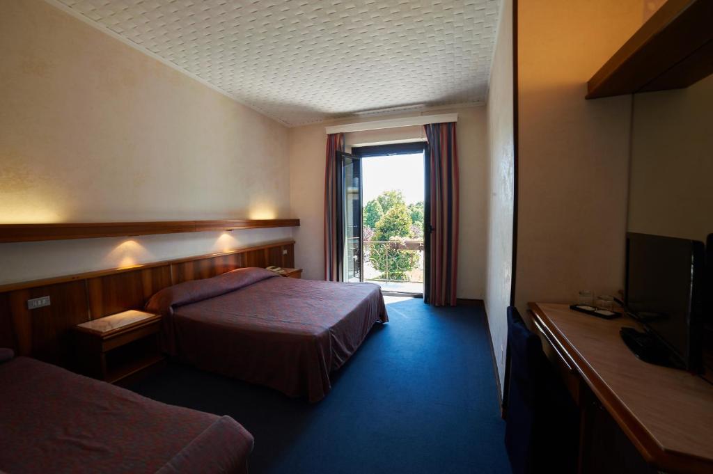 Una cama o camas en una habitación de Hotel Giardino