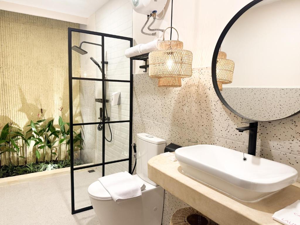 a bathroom with a sink and a shower at Canggu Villas Family Yogyakarta in Ngaglik