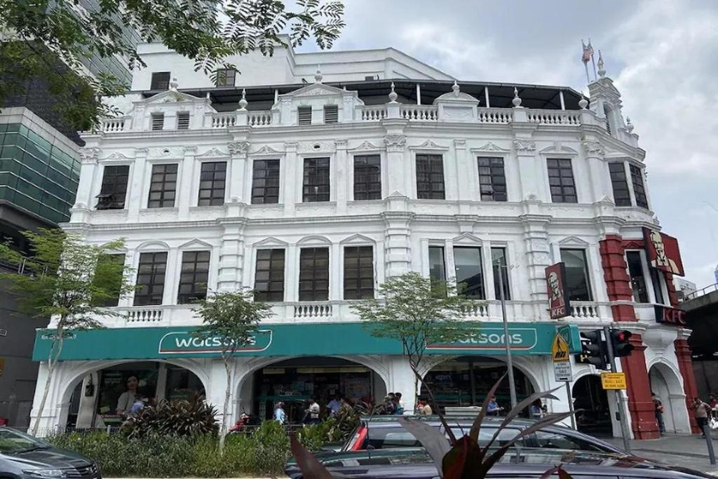 a large white building on a city street at Hotel AL Amin in Kuala Lumpur