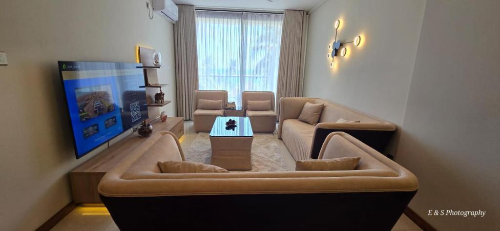 a living room with a couch and a table at Chilax By The Ocean in Dehiwala