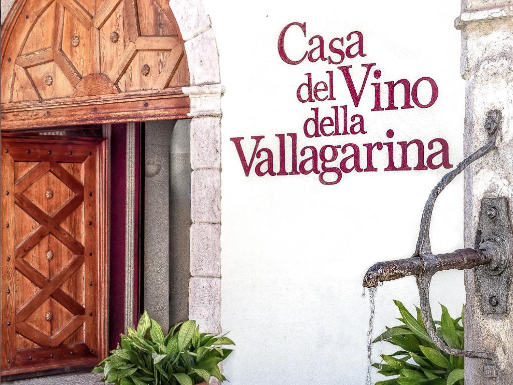 a door and a sign on the side of a building at Casa del Vino della Vallagarina in Isera