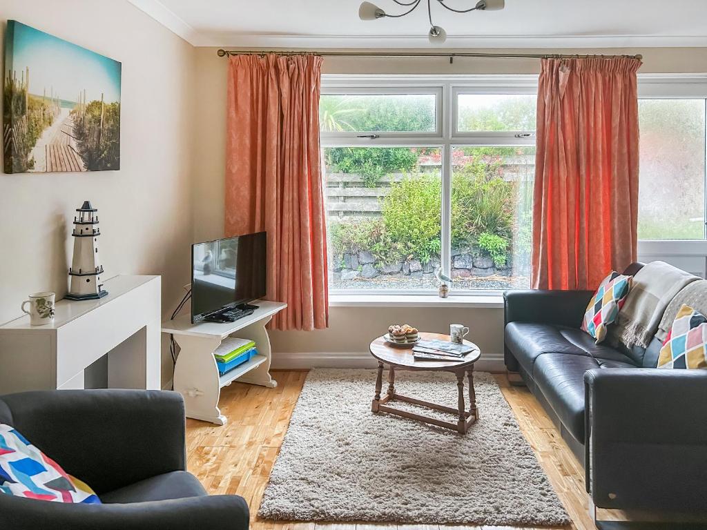 モリオンにある6 The Coveのソファとテレビのあるリビングルーム