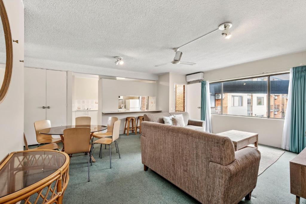 a living room with a couch and a table at Beachside Retreat Sandcastles 231 in Coffs Harbour