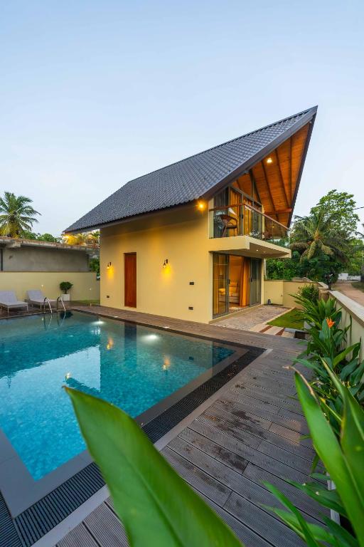 a house with a swimming pool in front of it at Sakun villa in Mirissa