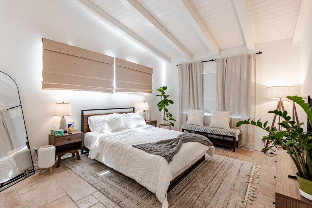 a bedroom with a bed and a couch and a television at Hillside Hideaway - Private Woodland Hills Canyon Suite in Woodland Hills