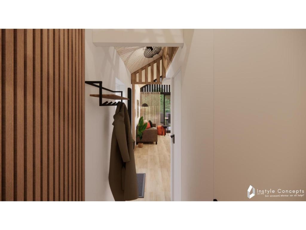 a hallway with a coat hanging on a wall at 6-person holiday home for relaxing retreat in Balkbrug