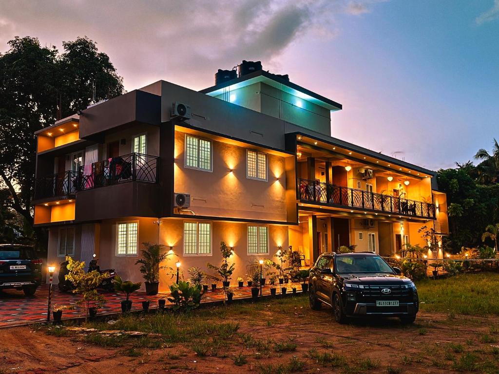 a house with a car parked in front of it at 88 GREEN FORT EDAPALLy in Ernakulam