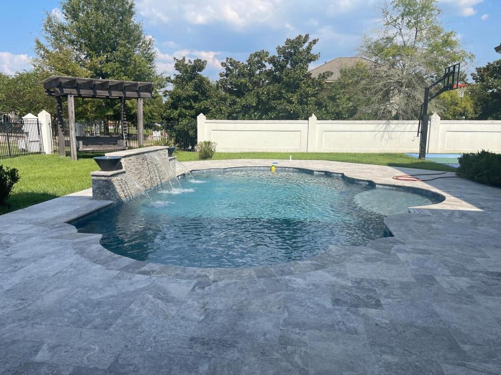 a small pool with a fountain in a yard at Cute Home with some Razzle Dazzle in Baton Rouge