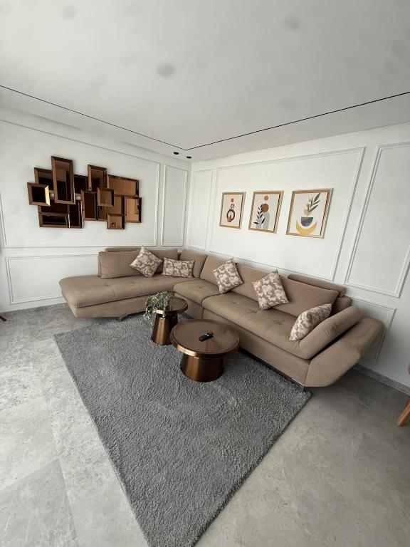 a living room with two couches and a rug at Metropoleparc luxury apparthotel in Casablanca