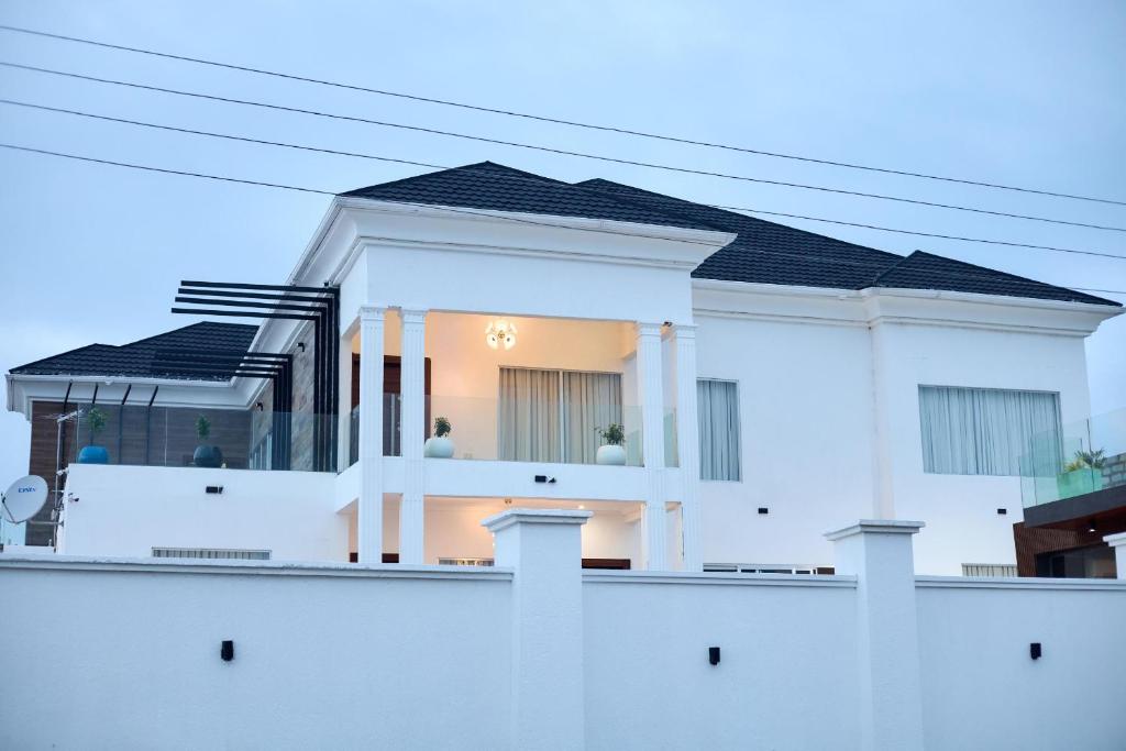 a white house with a black roof at Villa Hills Hotel 