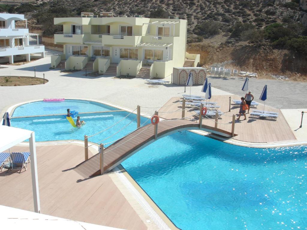 a view of a pool with people playing in it at Royal Beach Hotel in Arkasa