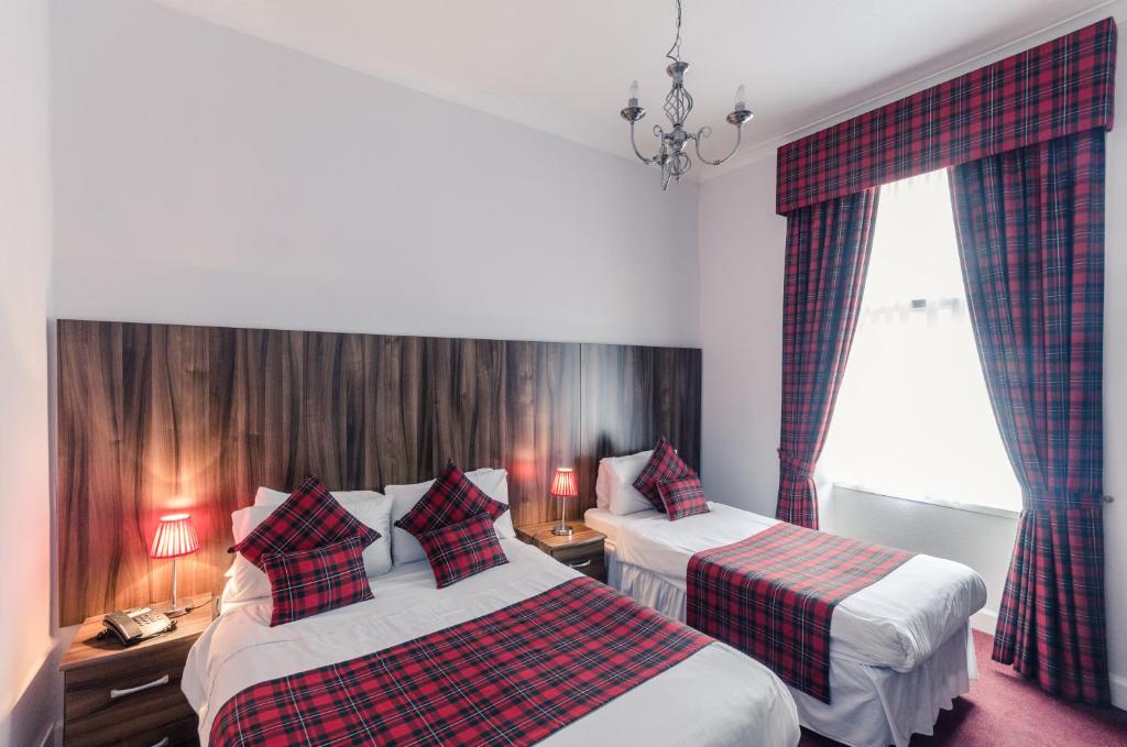 Habitación de hotel con 2 camas y ventana en Argyll Guest House, en Glasgow