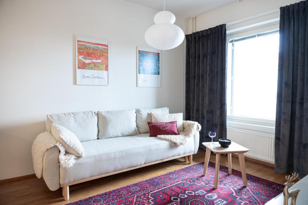 un salon avec un canapé et une table dans l'établissement Gammi Apartments - Classy Lapland Stay in Rovaniemi Centre for up to 4 Guests, à Rovaniemi
