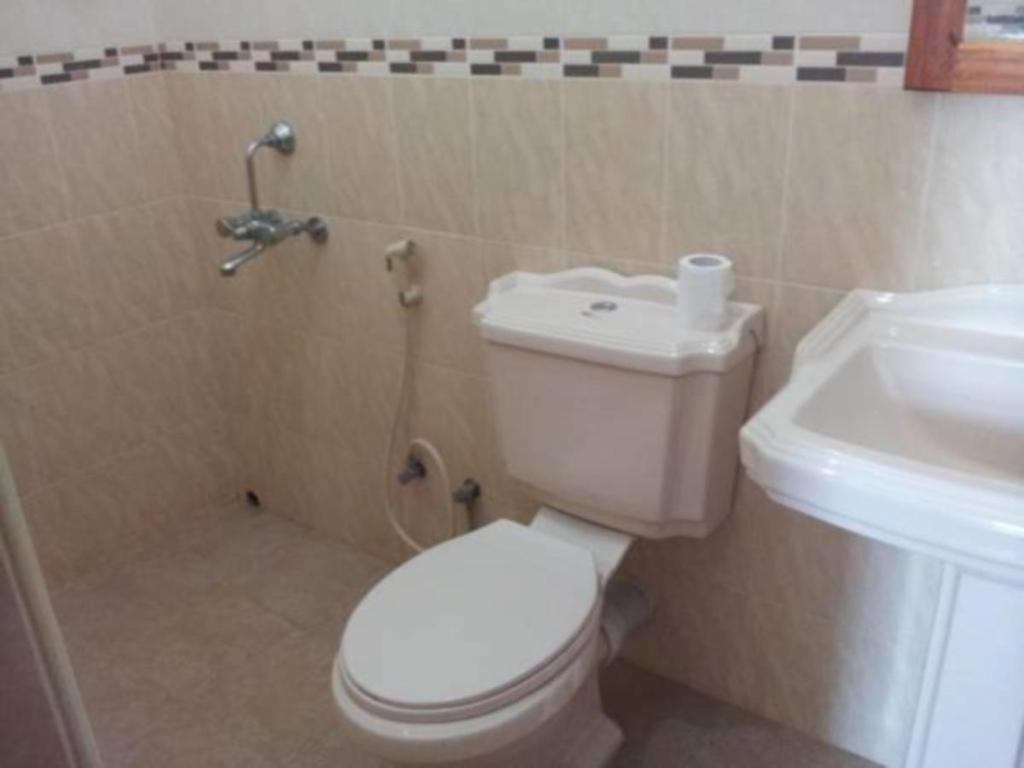 a bathroom with a toilet and a sink at Dads Holiday Home in Gongawala