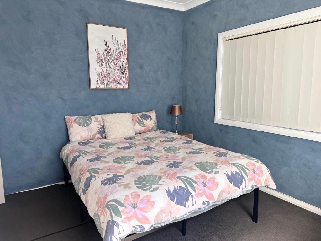 a bedroom with a bed with a floral bedspread at Charlestown Central 7 Bedrooms Front House and Back Unit in Charlestown