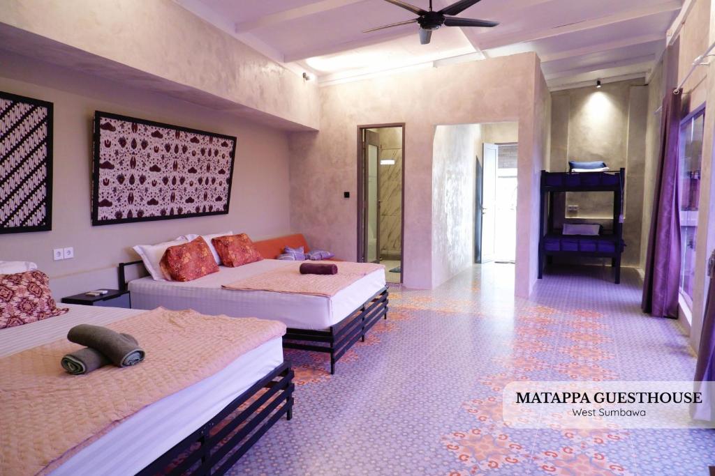 a bedroom with two beds and a piano at Matappa Guest House in Pulau Sarang