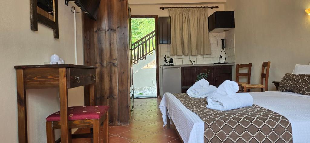 a bedroom with a bed with towels on it at Panorama Elati in Elati Trikalon