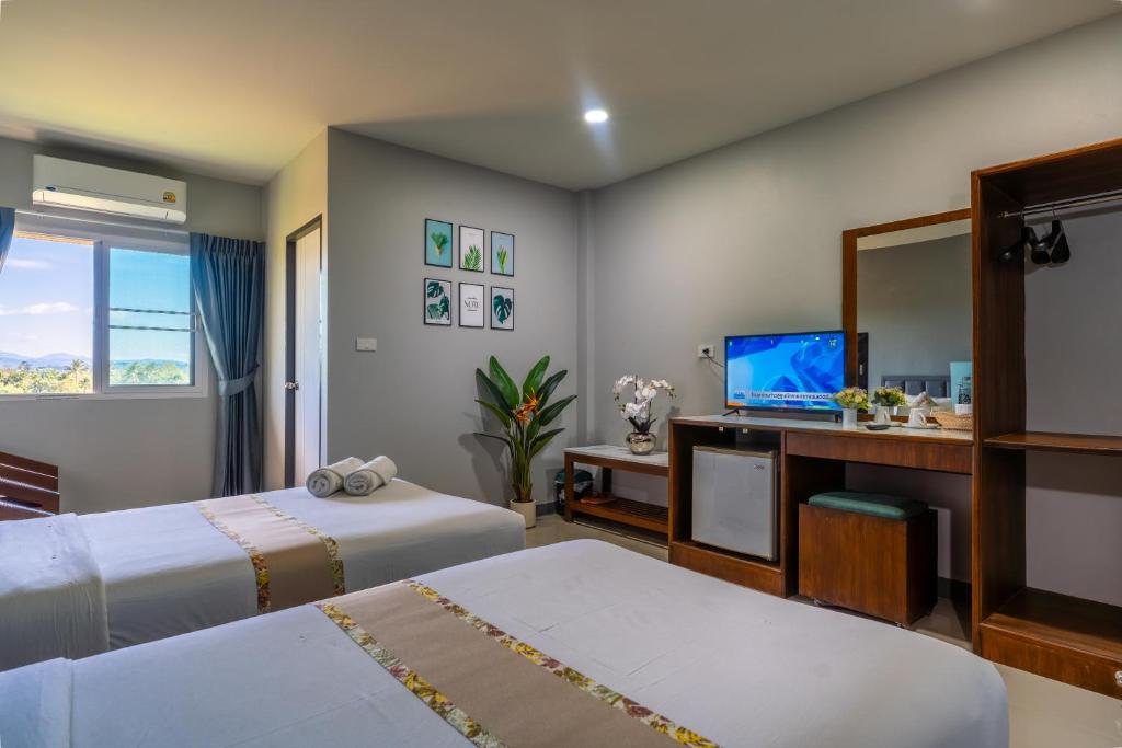 Postel nebo postele na pokoji v ubytování KYP Hotel โรงแรมขุนยูวเพลส