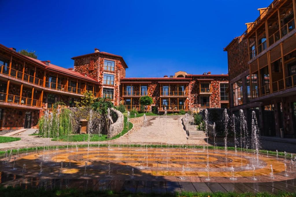 a courtyard with a fountain in front of a building at Red Bridge Yerevan in Yerevan