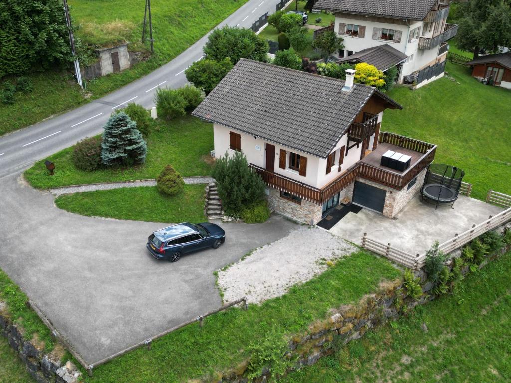 a car parked in front of a house at Chalet Avenir in Saint-Jean-dʼAulps