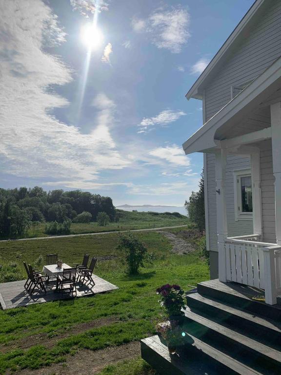 a porch of a house with a table and chairs at Apartment Senja in Senja