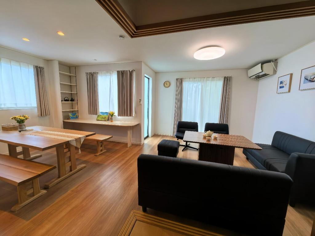 a living room with a couch and a table at 一棟貸民泊西戸崎駅前 in Fukuoka