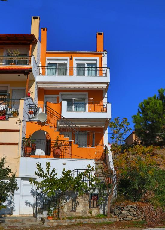 an orange and white building on a hill at Summer House Nea Peramos in Nea Peramos