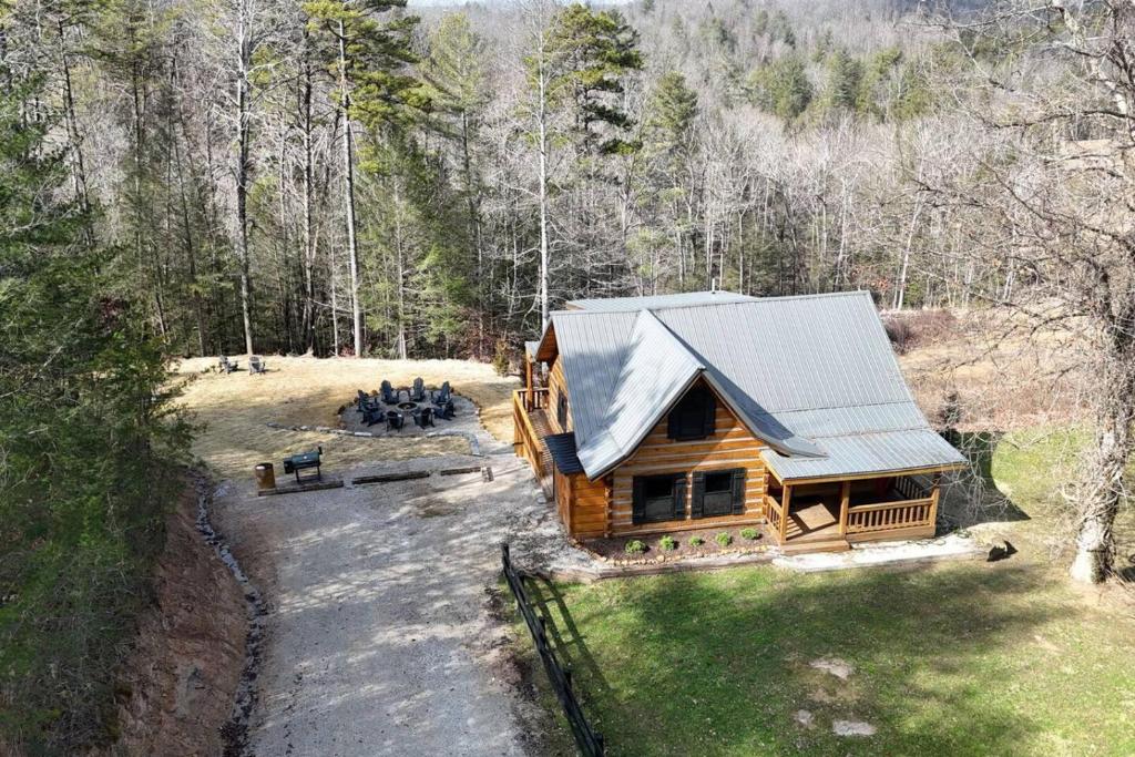 an aerial view of a log cabin in the woods at Karaoke Hot Tub 1GB WiFi - The Rock House - LUX in Rogers