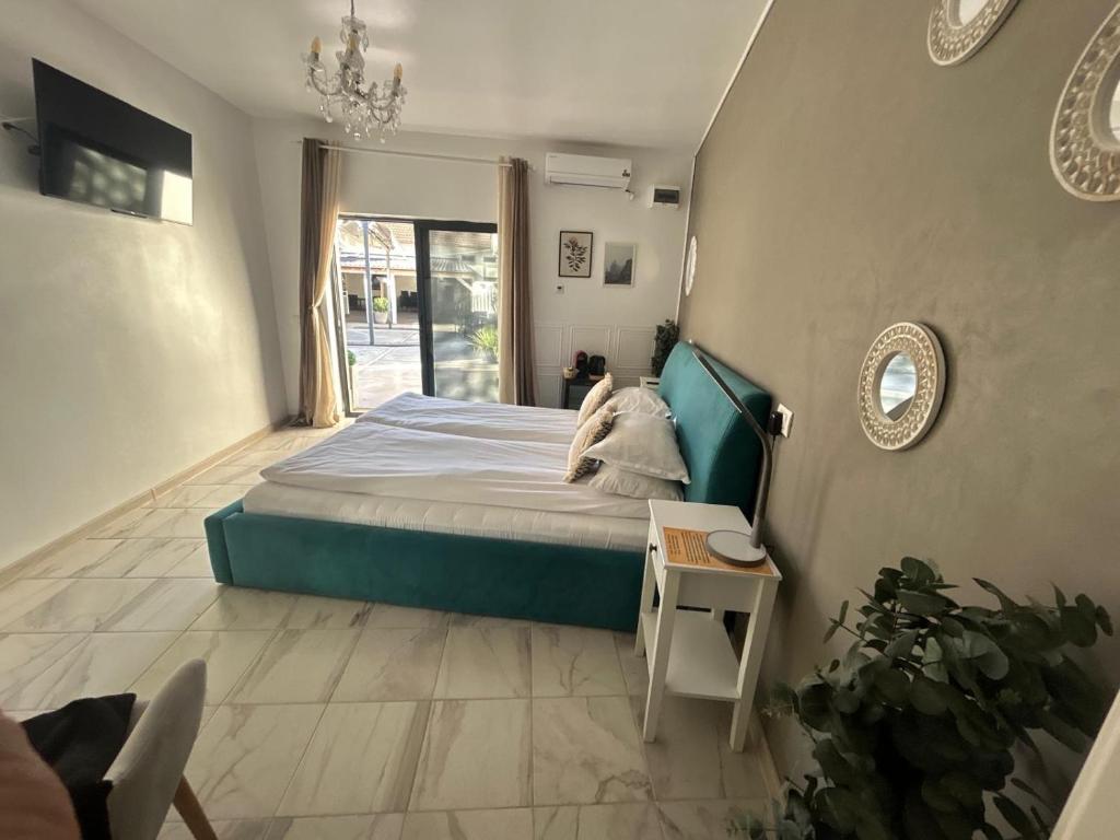 a bedroom with a bed and a table and a mirror at Popasul Castelului in Hunedoara