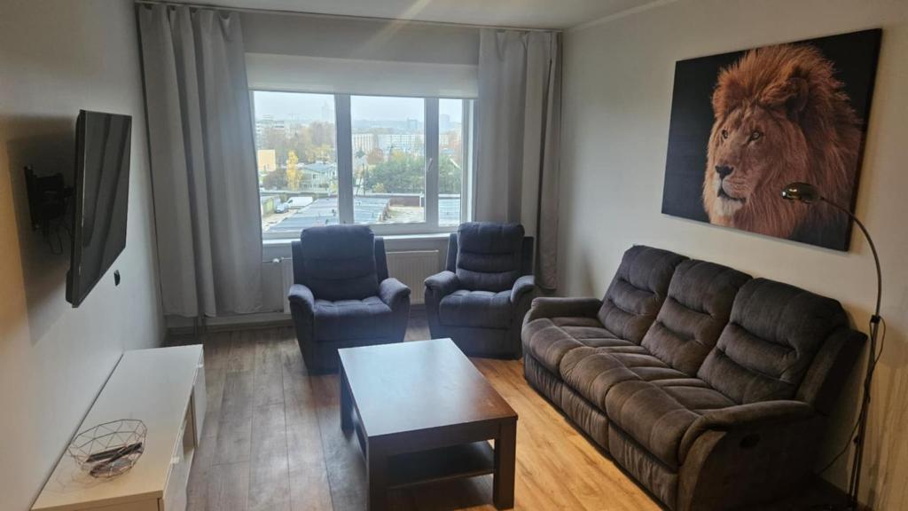 a living room with a couch and two chairs at Lion Stay in Tartu