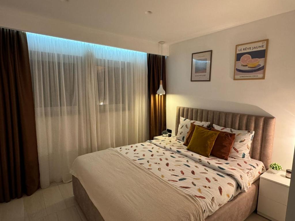 a bedroom with a large bed and a window at White Shell Sarajevo - Cozy & Stylish Apartment in Old Town in Sarajevo