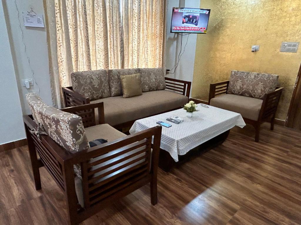 a living room with a couch and a table at Shiv - The Luxurious Gold Studio in Jaipur in Jaipur