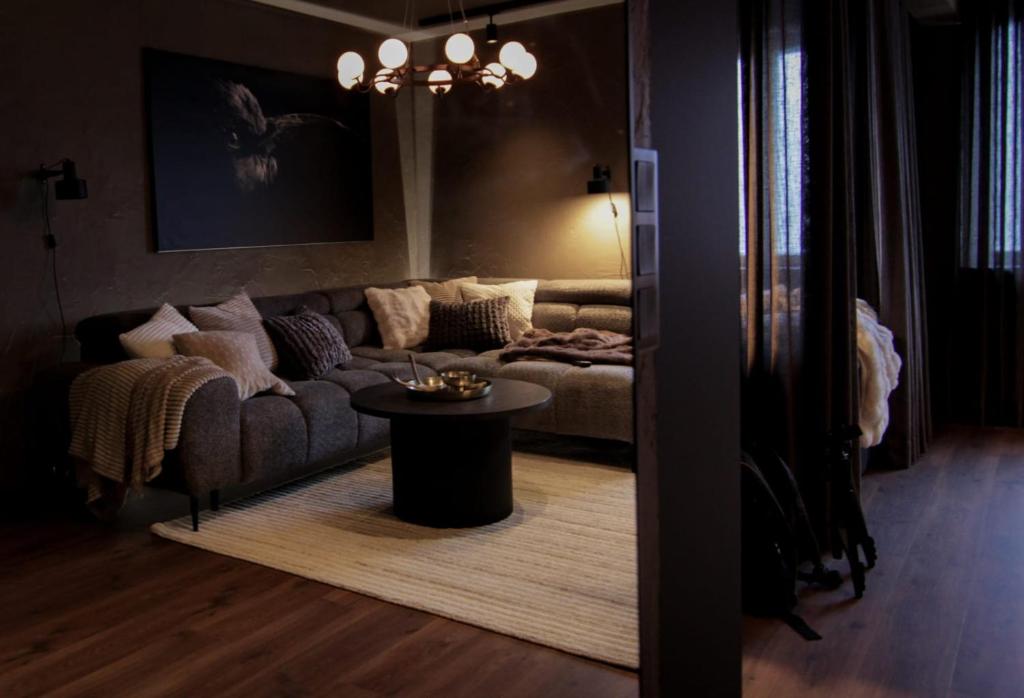 a living room with a couch and a table at Stylish City Suite in the Heart of Jyväskylä in Jyväskylä