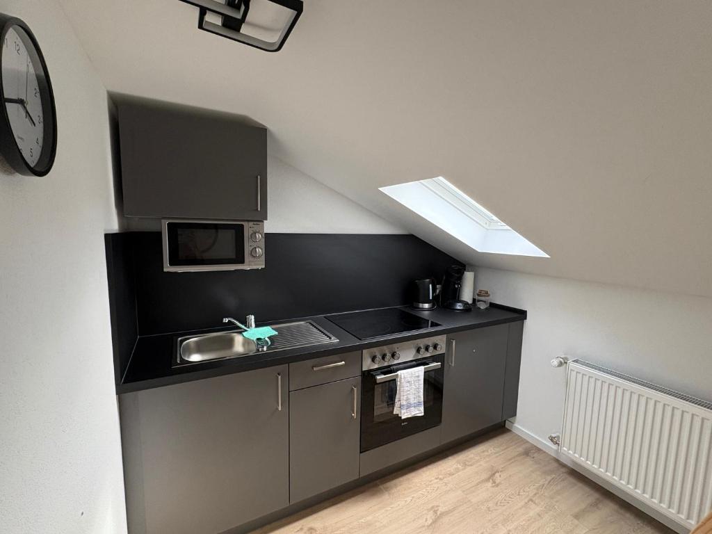 a small kitchen with a sink and a stove at RheinSchatz Apartments 3 in Oberwesel