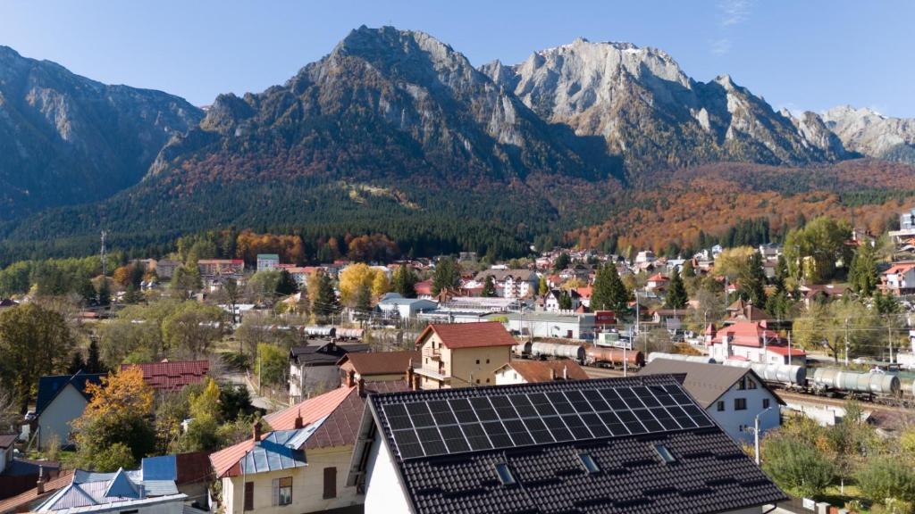 a small town with mountains in the background at Casa Orhideea in Buşteni