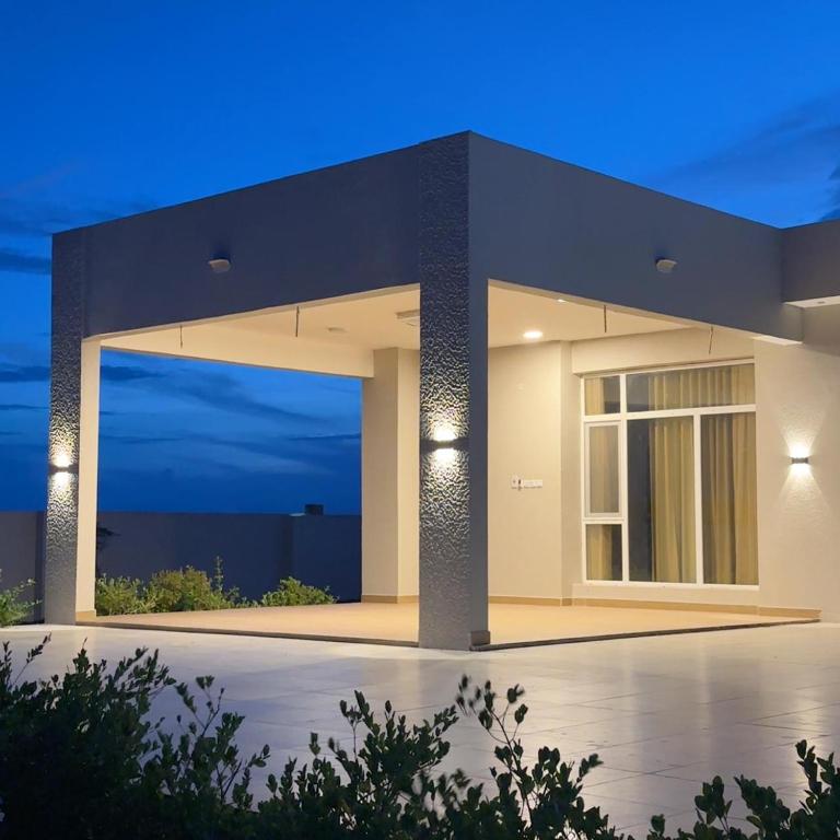 a modern house with a night view at Alhana Oasis in Badīyah
