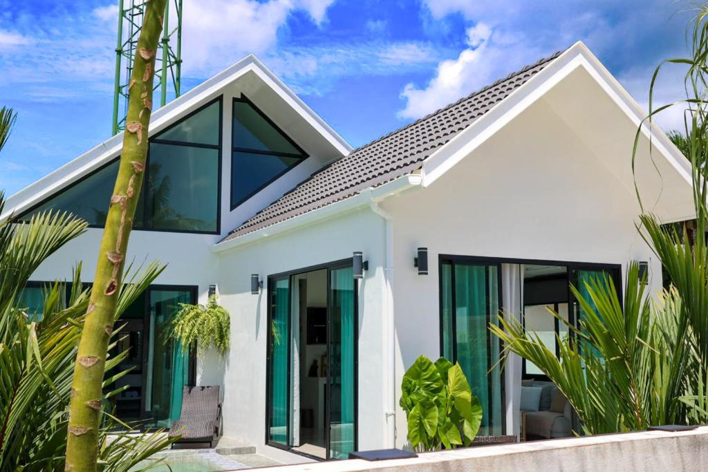 a white house with large glass doors at Modern 2BR Pool Villa - Near Ao Nang Beach in Ao Nang 