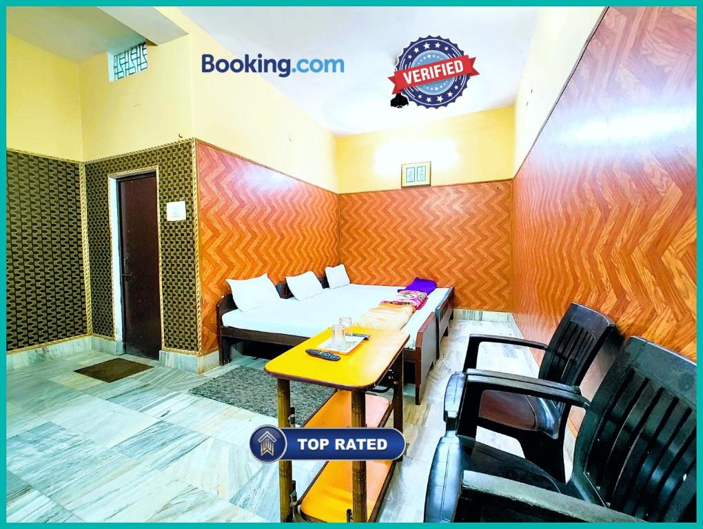 a room with a table and chairs and a sign on the wall at Hotel Shilpa Teerth Palace Guest House Near Vishwanath Temple - #Fully Air Conditioned Rooms #Restaurant And Wi-fi Facility - Best Prmium Hotel In Varanasi in Kashi